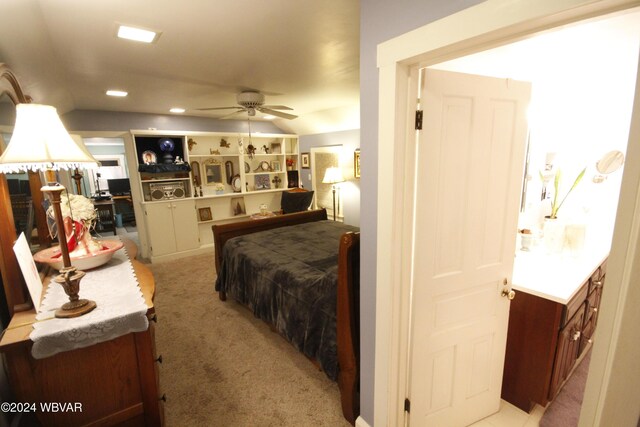 bedroom featuring light colored carpet and lofted ceiling