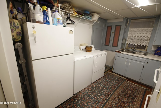 washroom featuring cabinets, independent washer and dryer, and sink