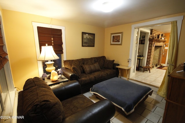 living room with light tile patterned floors and a brick fireplace