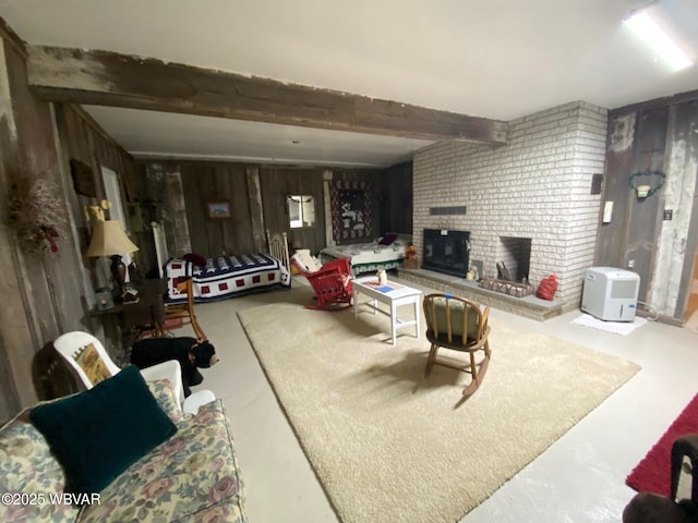 10296 Renovo Rd, North Bend, PA 17760 - living room featuring a brick fireplace, beam ceiling, wood walls, and finished concrete floors