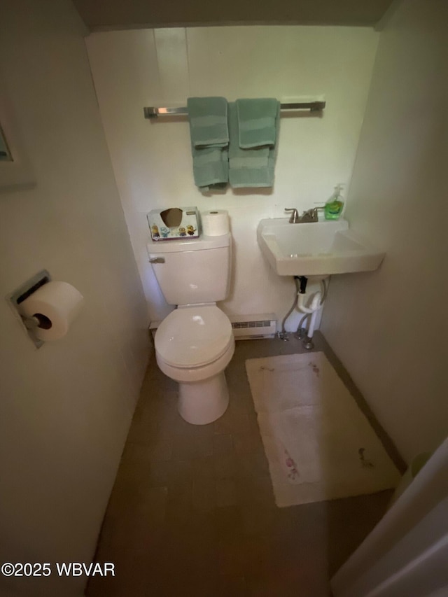 10296 Renovo Rd, North Bend, PA 17760 - bathroom with a baseboard heating unit, toilet, a sink, and tile patterned floors