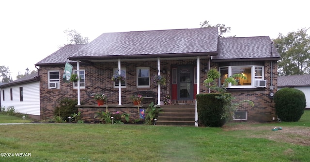 bungalow-style house with a front yard and covered porch