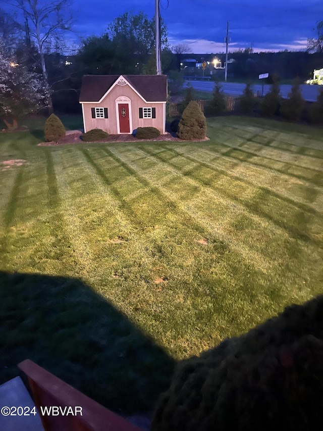 yard at dusk with an outbuilding