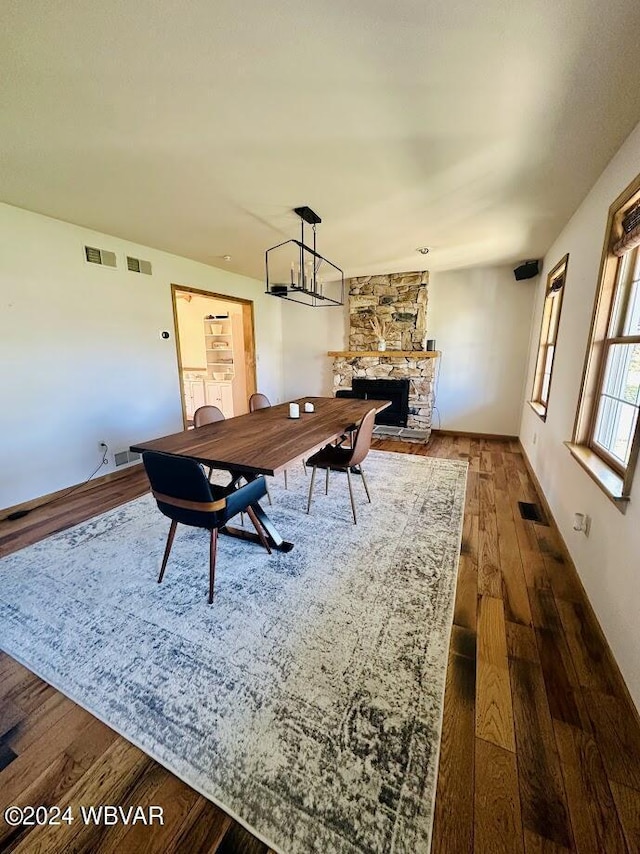 home office featuring hardwood / wood-style floors and a fireplace