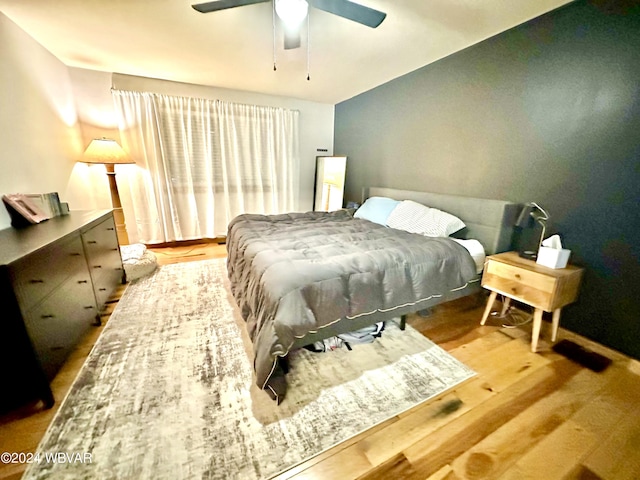 bedroom with ceiling fan and wood-type flooring