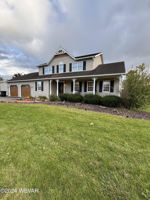 view of front of property with a garage and a front lawn