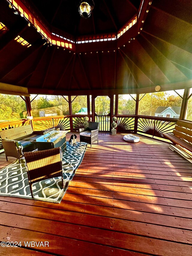 wooden deck with a gazebo and outdoor lounge area