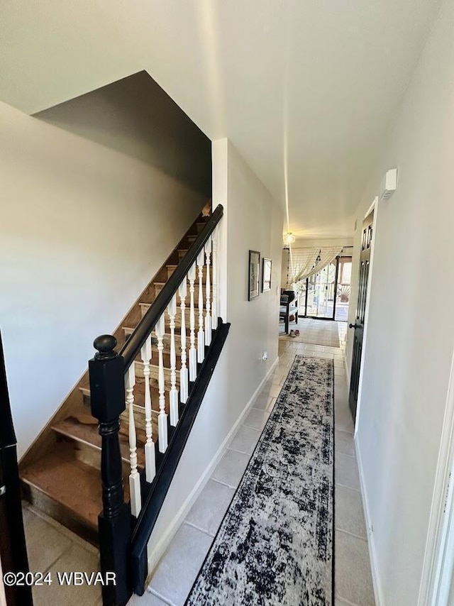 stairway featuring tile patterned floors