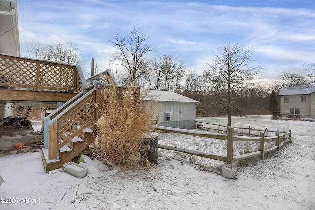 yard covered in snow featuring a deck