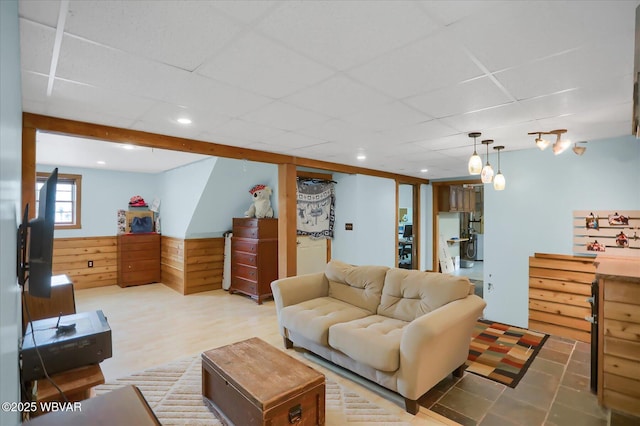 living room with wood-type flooring and a paneled ceiling