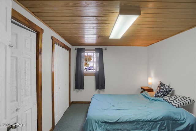 carpeted bedroom featuring wood ceiling