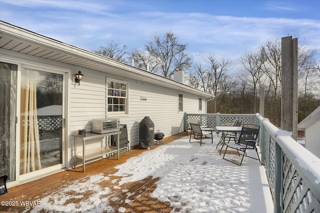 snow covered deck featuring area for grilling