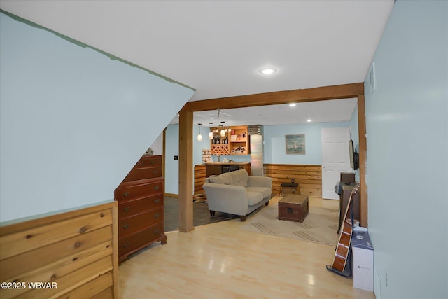 living room with beam ceiling and light hardwood / wood-style floors