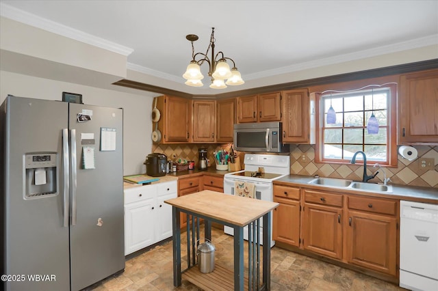 kitchen featuring tasteful backsplash, sink, ornamental molding, pendant lighting, and stainless steel appliances