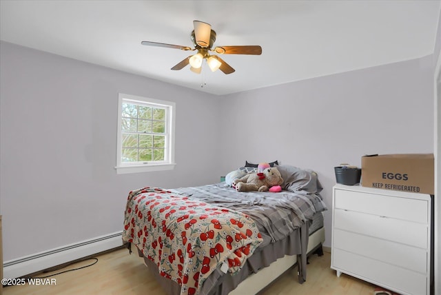 bedroom featuring ceiling fan, a baseboard radiator, and light wood-type flooring