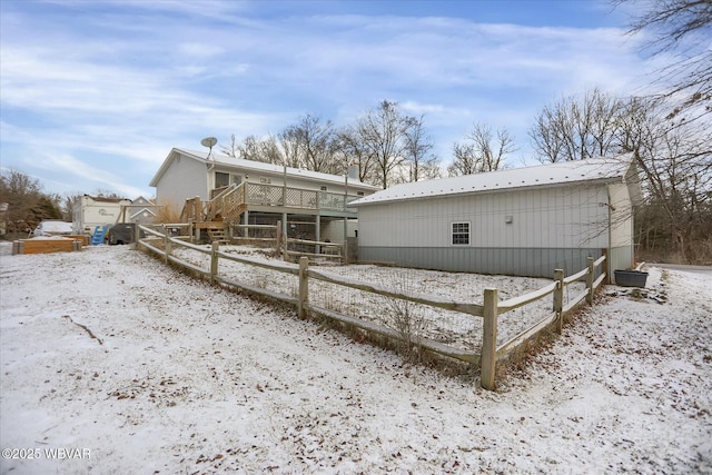 view of snowy exterior with a wooden deck