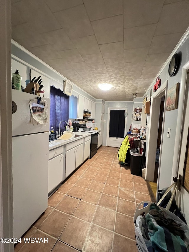 kitchen featuring black range with electric cooktop, sink, light tile patterned floors, white fridge, and white cabinetry