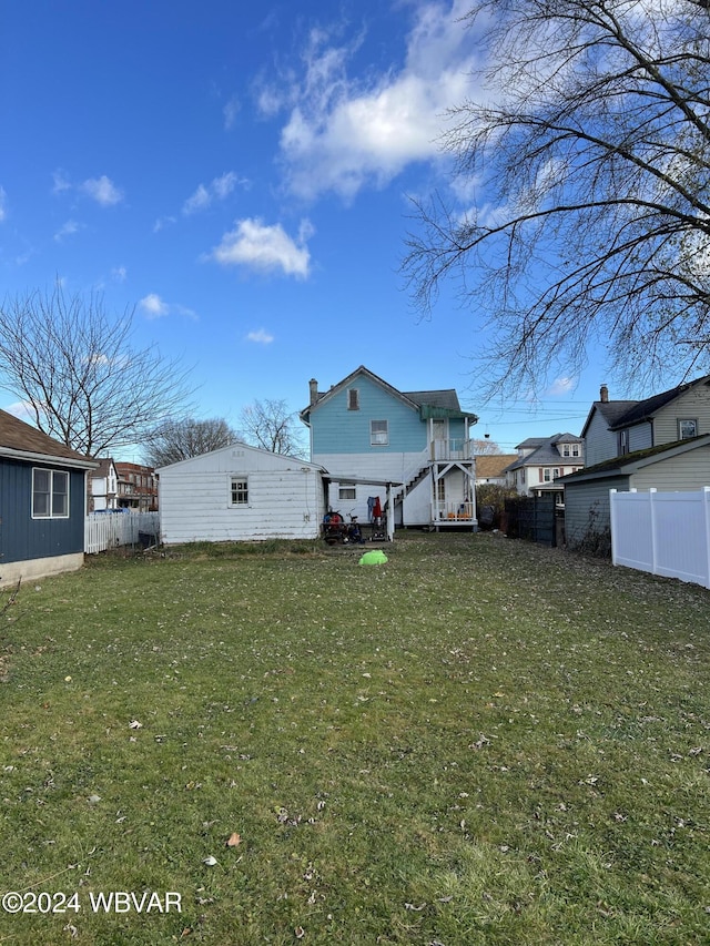 rear view of house featuring a yard