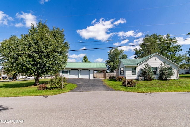 view of front of property with a garage and a front yard