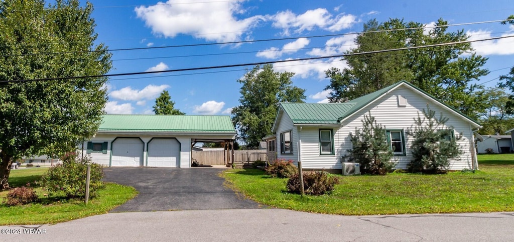 view of front of house with a garage and a front lawn