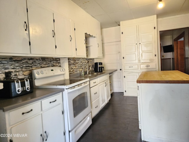 kitchen featuring white cabinetry, sink, a center island, backsplash, and electric stove