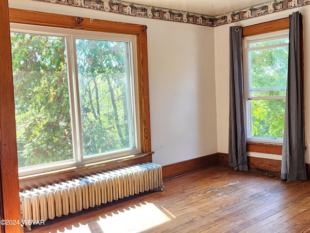 interior space with hardwood / wood-style flooring and radiator