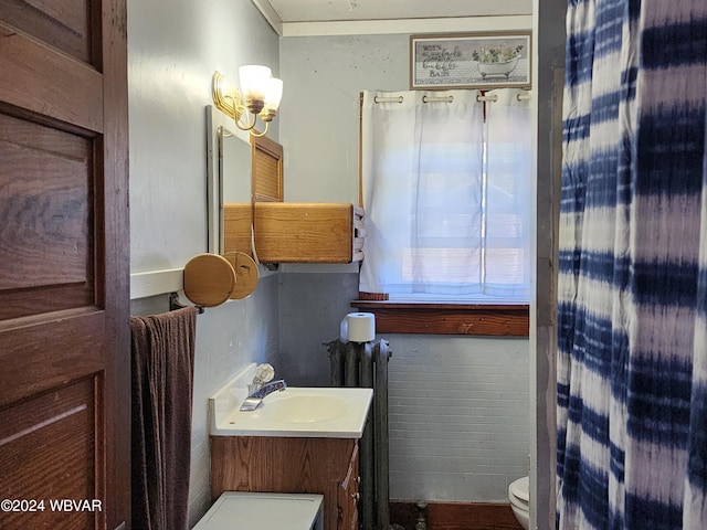 bathroom featuring vanity, toilet, and radiator