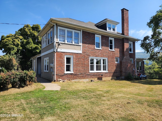 rear view of property featuring a yard