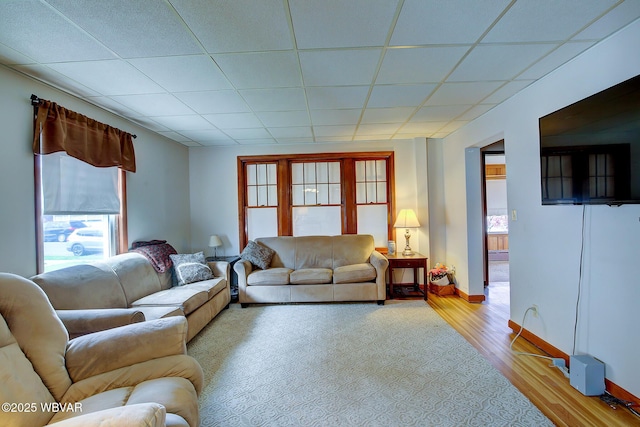 104 Pearl St, Lock Haven, PA 17745 - living room with healthy amount of natural light, wood finished floors, a paneled ceiling, and baseboards