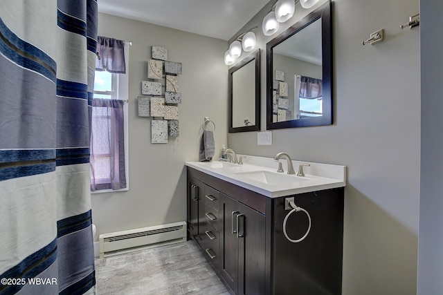 104 Pearl St, Lock Haven, PA 17745 - full bath with a baseboard heating unit, wood finished floors, and double vanity