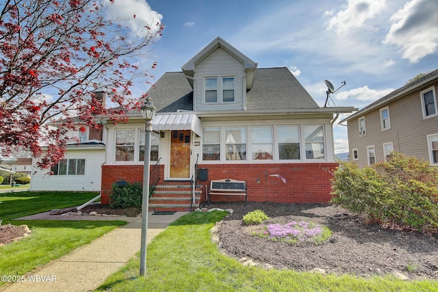 104 Pearl St, Lock Haven, PA 17745 - bungalow-style home with entry steps, brick siding, a front yard, and roof with shingles