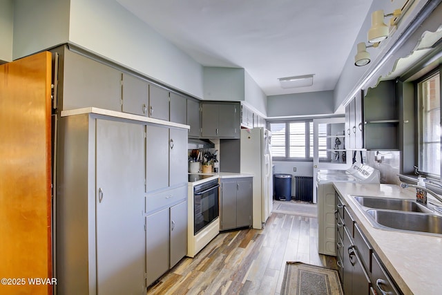 104 Pearl St, Lock Haven, PA 17745 - kitchen featuring gray cabinets, electric stove, a sink, white fridge with ice dispenser, and light wood-style flooring