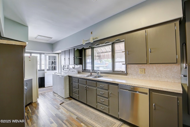 104 Pearl St, Lock Haven, PA 17745 - kitchen featuring stainless steel dishwasher, a sink, independent washer and dryer, light countertops, and light wood-style floors