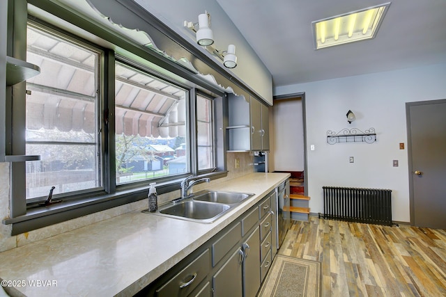 104 Pearl St, Lock Haven, PA 17745 - kitchen with a sink, radiator heating unit, light wood-type flooring, light countertops, and dishwasher