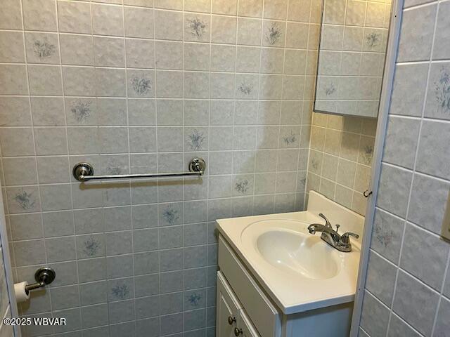 104 Pearl St, Lock Haven, PA 17745 - bathroom featuring vanity and tile walls
