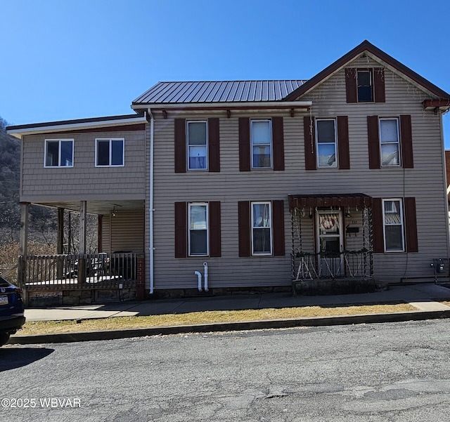 townhome / multi-family property featuring metal roof and a porch