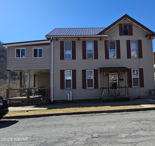 townhome / multi-family property with covered porch and metal roof