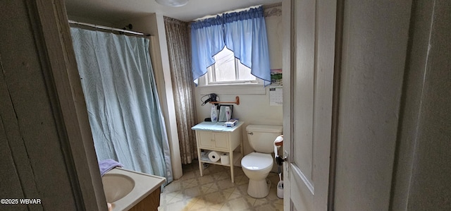 full bathroom with toilet, tile patterned floors, and a shower with shower curtain