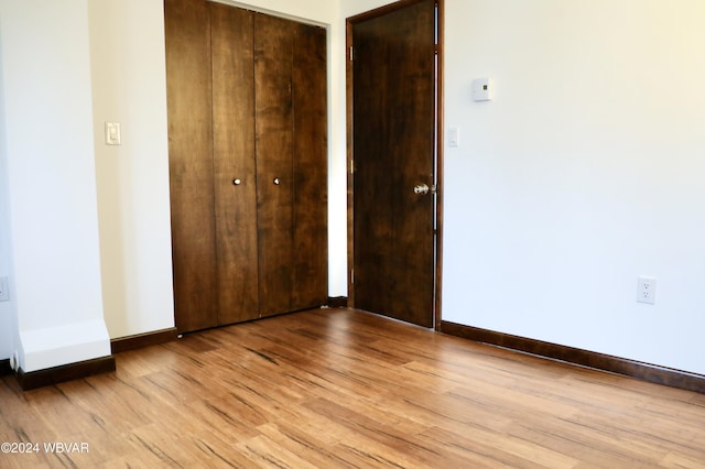 unfurnished bedroom featuring light wood-type flooring