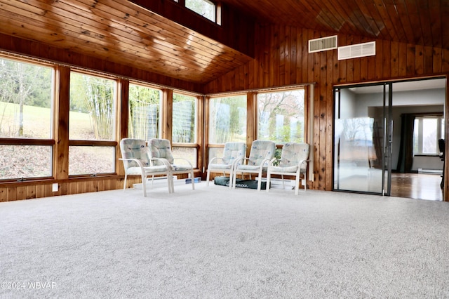 unfurnished sunroom featuring vaulted ceiling and wooden ceiling