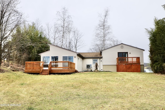 rear view of property featuring a deck and a lawn