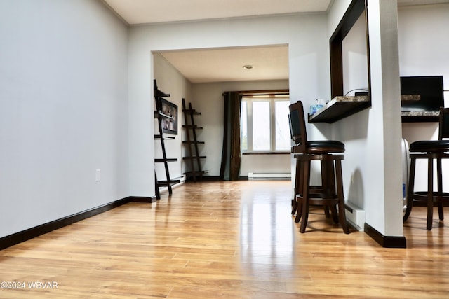 miscellaneous room with light wood-type flooring and baseboard heating