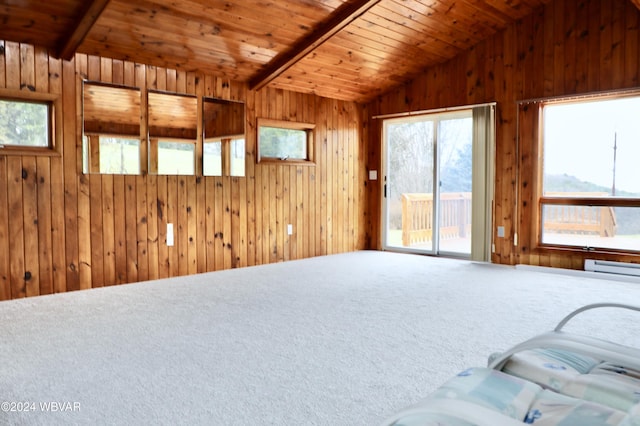 carpeted living room featuring lofted ceiling with beams, wooden walls, and wood ceiling