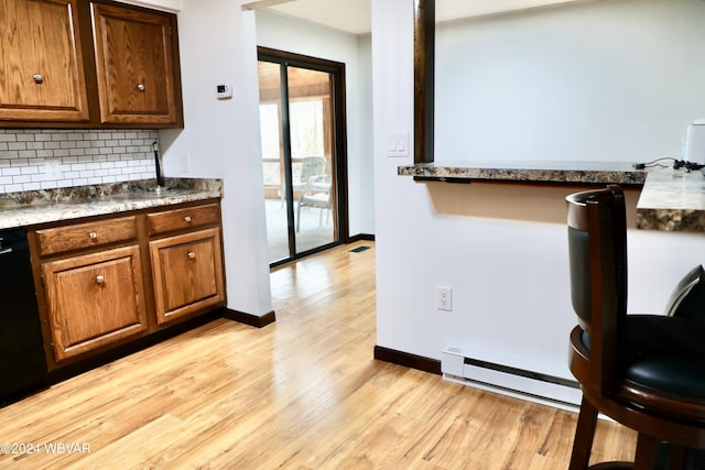 kitchen with decorative backsplash, dishwasher, light hardwood / wood-style floors, and a baseboard radiator