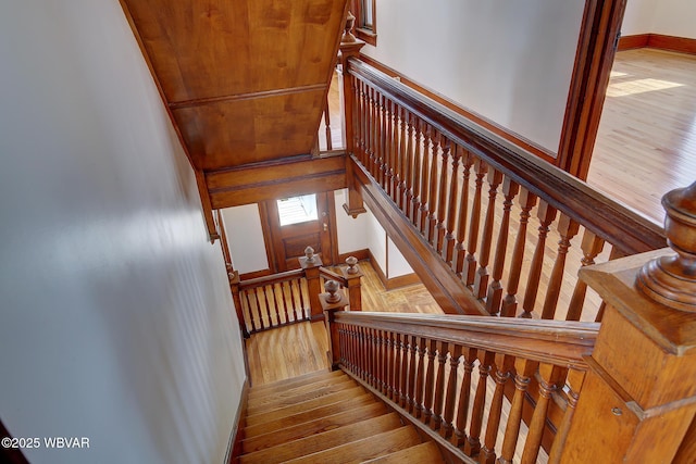 stairs featuring hardwood / wood-style floors and baseboards