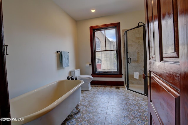bathroom featuring baseboards, a stall shower, a soaking tub, recessed lighting, and toilet