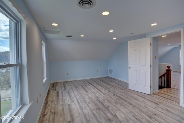 bonus room featuring light wood-type flooring, lofted ceiling, visible vents, and recessed lighting