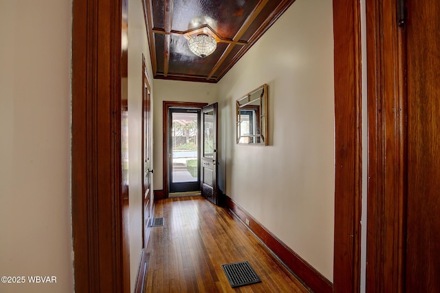entryway featuring dark wood-style flooring, visible vents, and baseboards