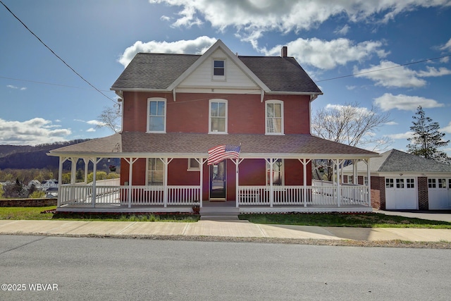 victorian home with a garage and covered porch