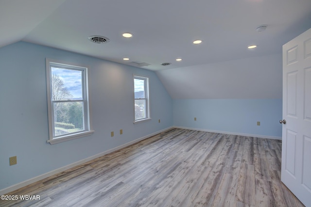 additional living space featuring visible vents, recessed lighting, wood finished floors, and lofted ceiling